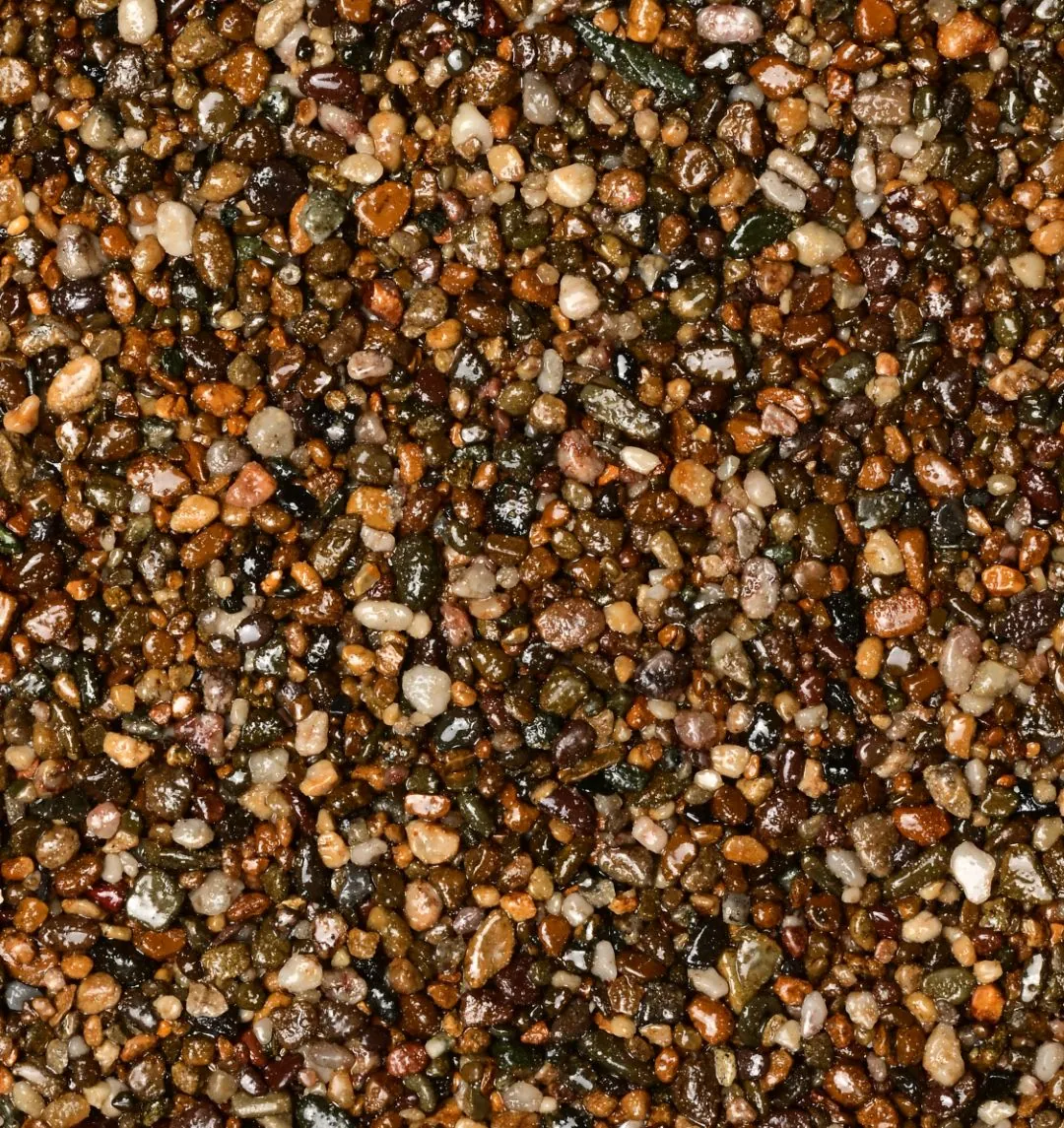 Kleurstaal harsgebonden grind Brittany Bronze: Kastanje- en bronsbruine korrels met honing-, amber- en enkele witte spikkels. Warm, diep en levendig